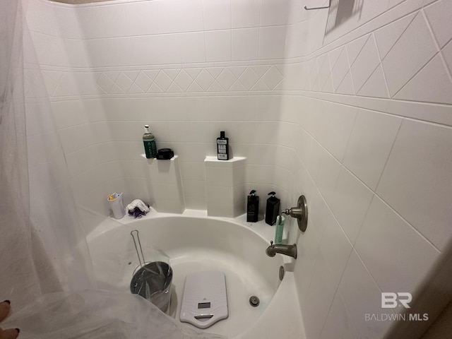 bathroom with shower / bath combo with shower curtain