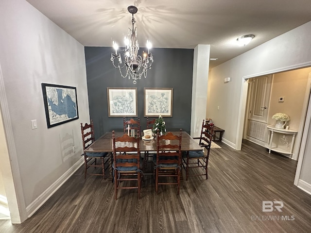 dining area featuring a notable chandelier and dark hardwood / wood-style flooring