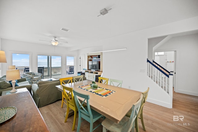 dining area featuring ceiling fan and light hardwood / wood-style floors