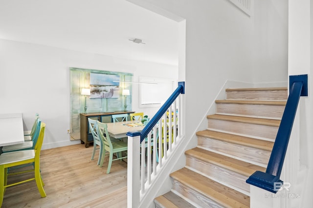 stairs featuring hardwood / wood-style floors