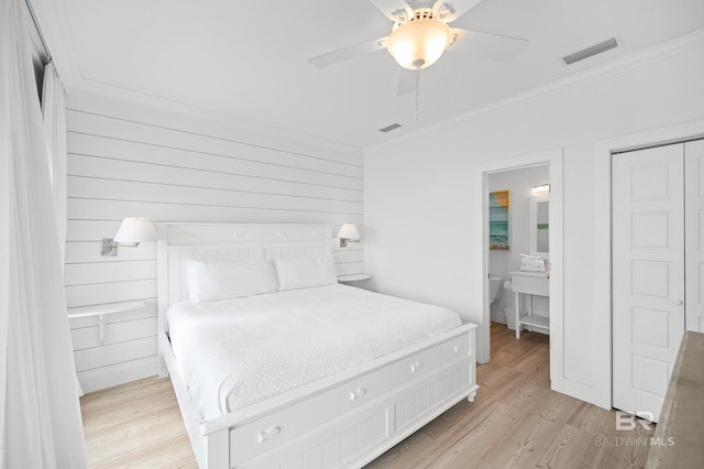 bedroom with ceiling fan, ornamental molding, ensuite bathroom, and light wood-type flooring