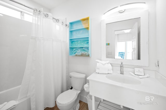 full bathroom featuring shower / tub combo with curtain, toilet, and sink