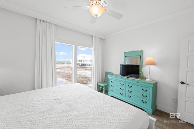 bedroom featuring wood-type flooring, ornamental molding, and ceiling fan