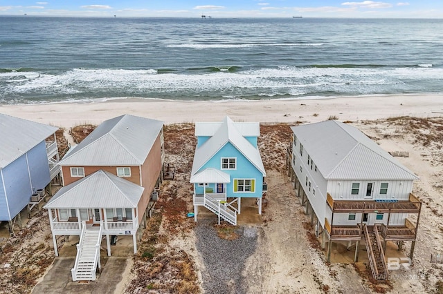 drone / aerial view with a water view and a beach view