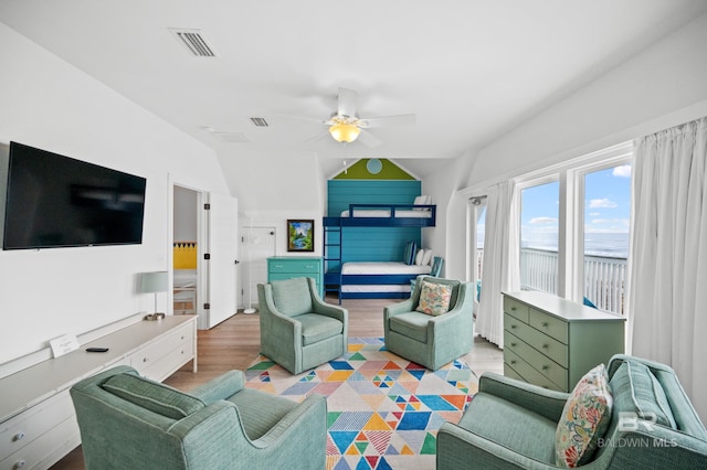 living room featuring lofted ceiling, light hardwood / wood-style floors, and ceiling fan