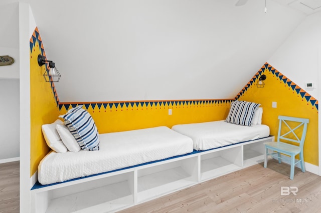 bedroom with lofted ceiling and hardwood / wood-style floors