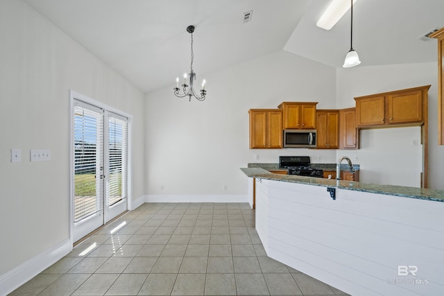 kitchen with sink, decorative light fixtures, black range oven, lofted ceiling, and light tile patterned flooring