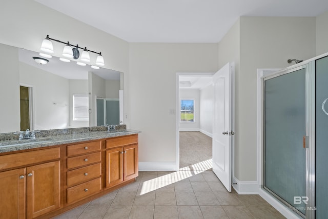 bathroom with tile patterned flooring, an enclosed shower, and vanity