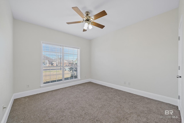 carpeted empty room featuring ceiling fan