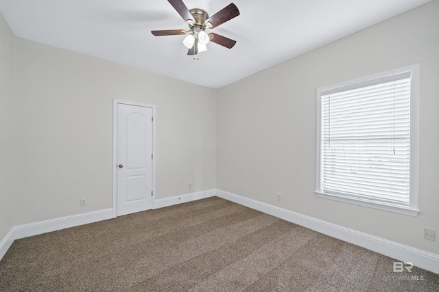 empty room with ceiling fan and carpet flooring