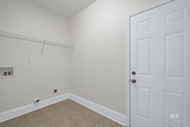 clothes washing area with electric dryer hookup, washer hookup, and light tile patterned floors