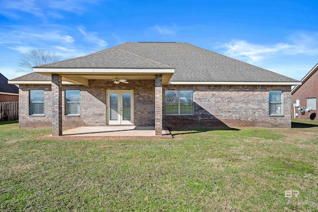 rear view of property featuring french doors, a yard, ceiling fan, and a patio