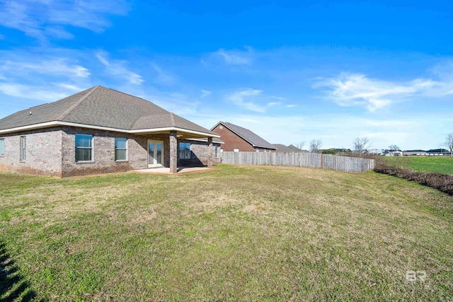 back of property featuring a lawn and a patio area