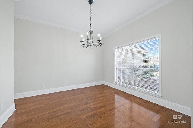 spare room with a notable chandelier, crown molding, and hardwood / wood-style flooring