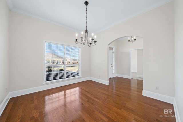 unfurnished dining area featuring wood-type flooring, crown molding, and a chandelier