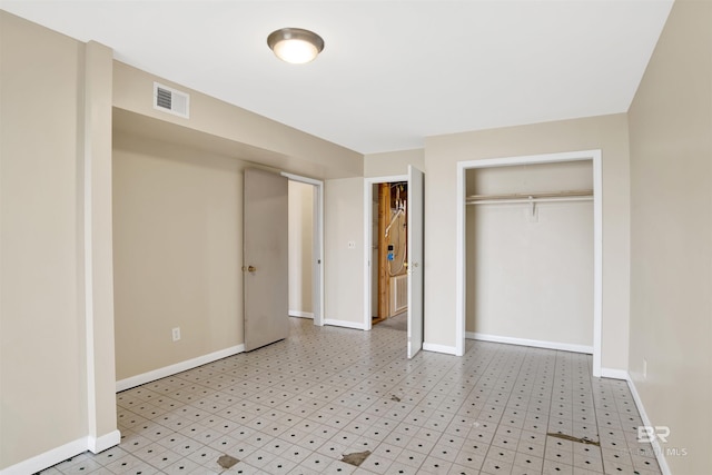 unfurnished bedroom with visible vents, baseboards, light floors, and a closet