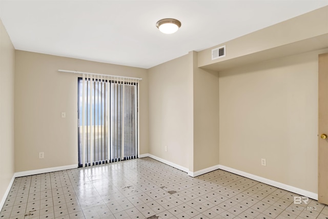 spare room with visible vents, baseboards, and light floors