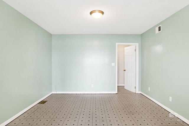 empty room featuring visible vents and baseboards