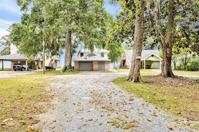 view of front of house featuring driveway and a carport