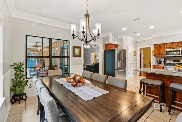 tiled dining area featuring ceiling fan with notable chandelier and crown molding