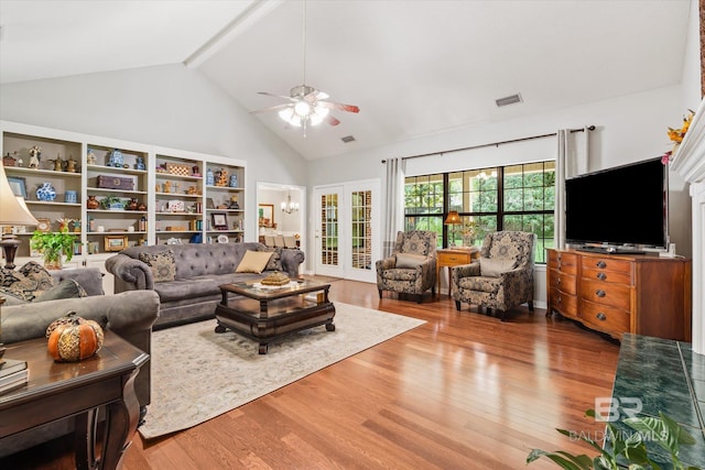 living room with beam ceiling, hardwood / wood-style flooring, ceiling fan, and french doors