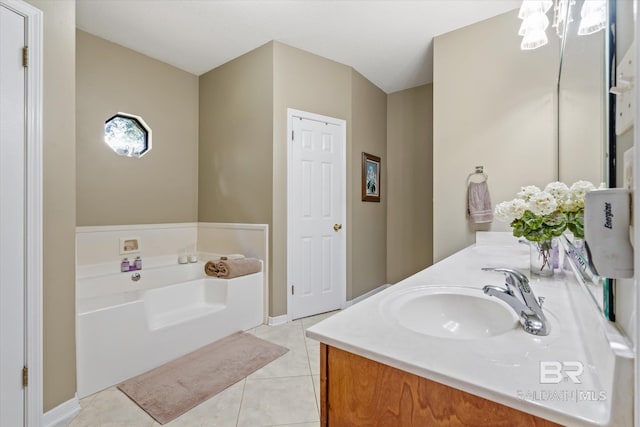 bathroom with vanity, tile patterned flooring, and a bath