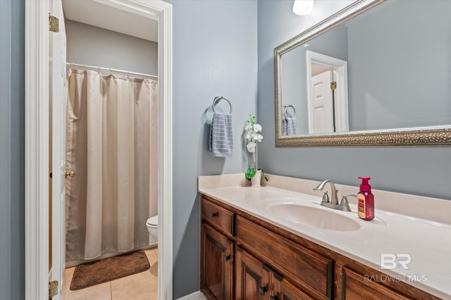 bathroom featuring tile patterned floors, toilet, and vanity