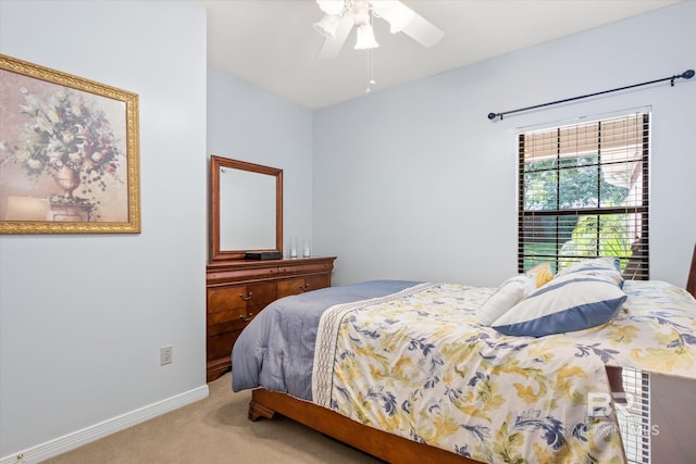 bedroom featuring ceiling fan and light carpet