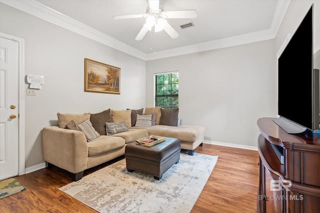 living room with ceiling fan, ornamental molding, and hardwood / wood-style floors