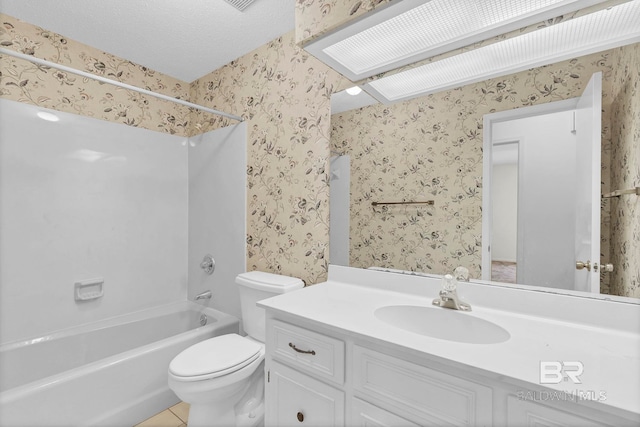 full bathroom with vanity, a textured ceiling, toilet, and washtub / shower combination