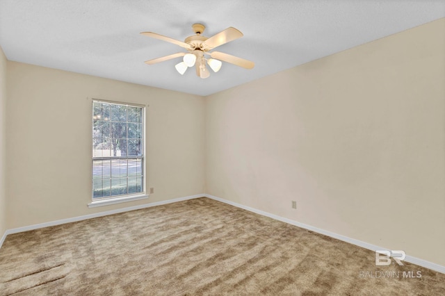 carpeted empty room with ceiling fan and a textured ceiling