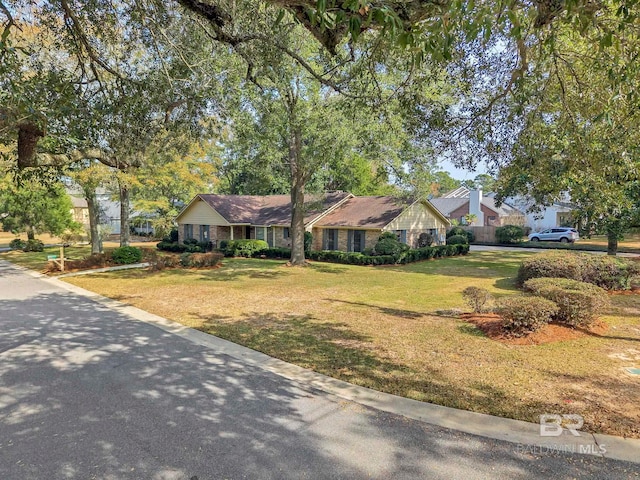 ranch-style home with a front lawn