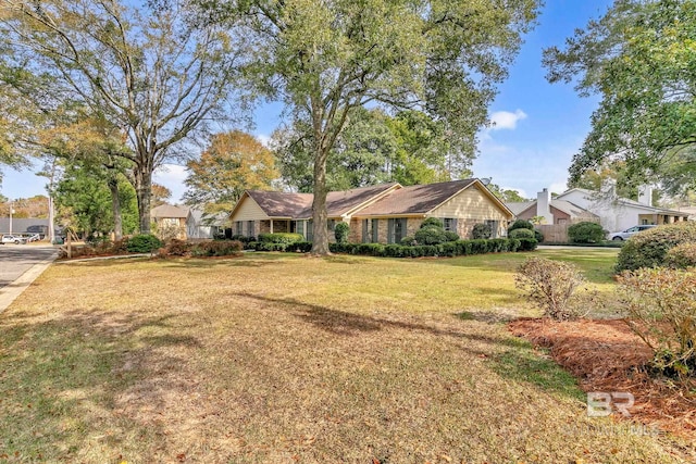 single story home with a front lawn