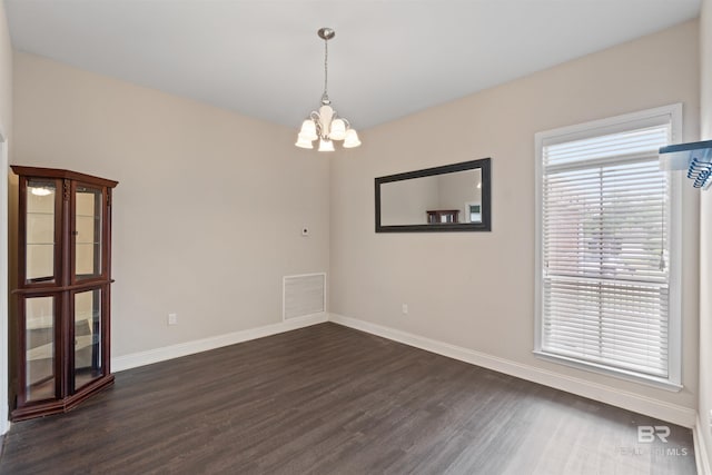 18971 Tralee Ct, Foley, AL 36535 - unfurnished room featuring dark wood finished floors, baseboards, and a chandelier