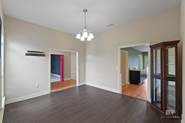18971 Tralee Ct, Foley, AL 36535 - spare room featuring wood finished floors, a chandelier, and baseboards