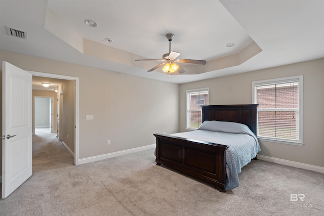 18971 Tralee Ct, Foley, AL 36535 - bedroom featuring a raised ceiling, baseboards, and light carpet