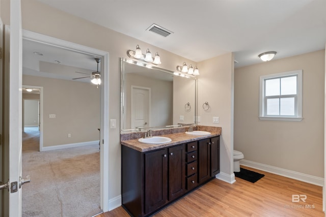 18971 Tralee Ct, Foley, AL 36535 - bathroom featuring toilet, ceiling fan, double vanity, and baseboards