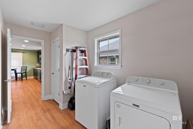 18971 Tralee Ct, Foley, AL 36535 - clothes washing area with washer and dryer, light wood-style floors, plenty of natural light, and baseboards