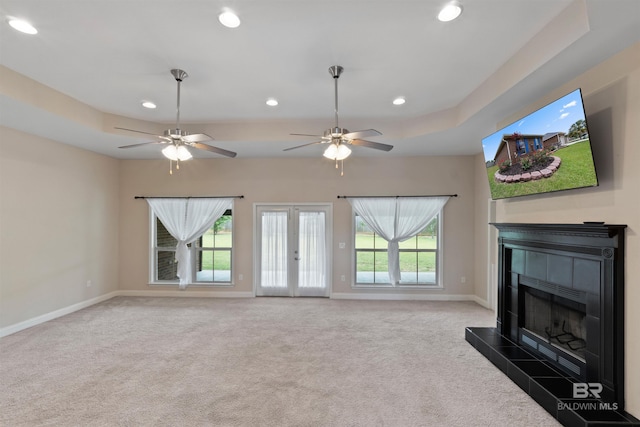 18971 Tralee Ct, Foley, AL 36535 - unfurnished living room featuring baseboards, recessed lighting, carpet floors, a fireplace, and french doors