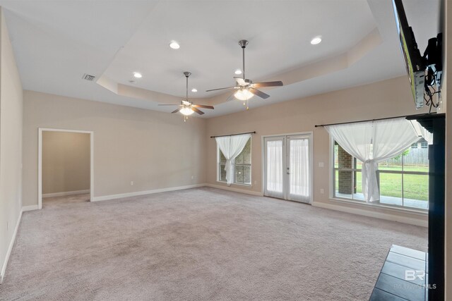 18971 Tralee Ct, Foley, AL 36535 - unfurnished living room with a tray ceiling, french doors, baseboards, healthy amount of natural light, and recessed lighting