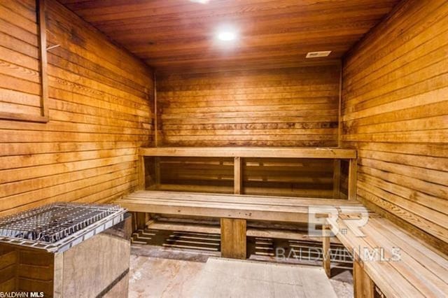 view of sauna featuring wooden walls and wood ceiling