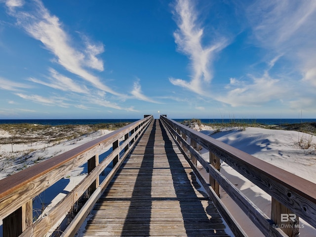 dock area with a water view and a view of the beach