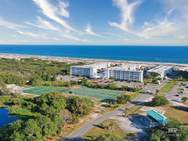 birds eye view of property with a water view and a view of the beach