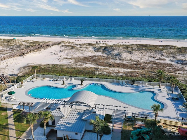 drone / aerial view with a water view and a beach view