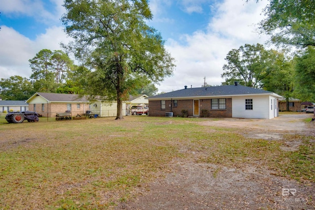 ranch-style home featuring central air condition unit and a front lawn