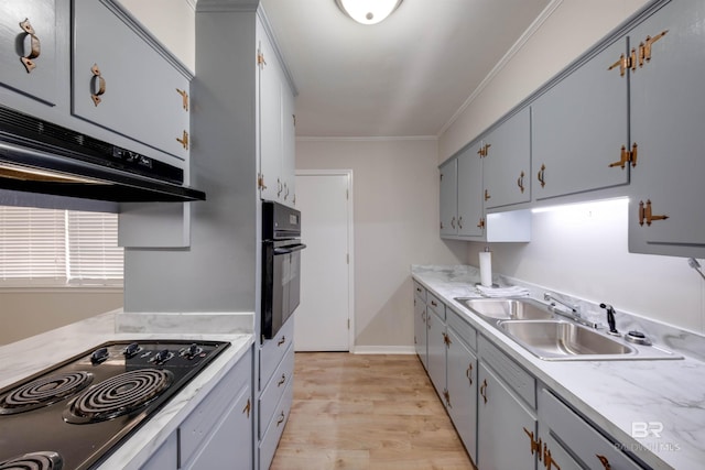 kitchen with black appliances, crown molding, gray cabinets, sink, and light hardwood / wood-style flooring