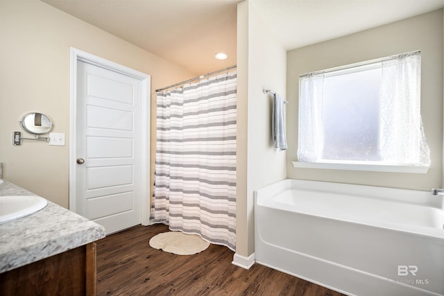 24189 Harvester Dr, Loxley, AL 36551 - full bathroom featuring a bath, vanity, wood finished floors, and a shower with shower curtain