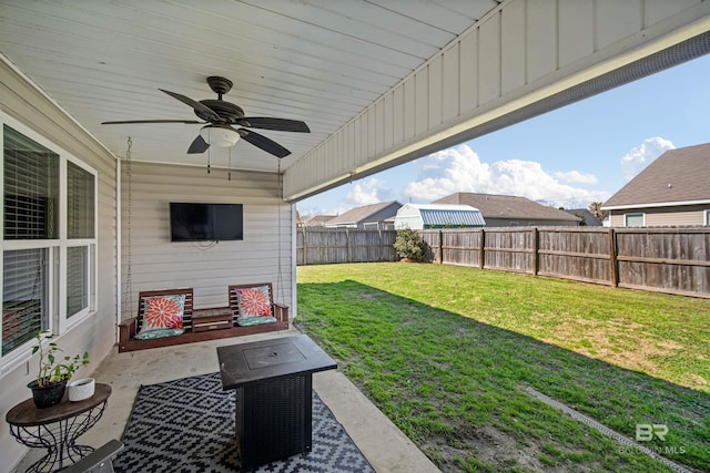 24189 Harvester Dr, Loxley, AL 36551 - fenced backyard with a ceiling fan and a patio area