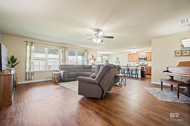 24189 Harvester Dr, Loxley, AL 36551 - living area with a ceiling fan, dark wood-style flooring, and a textured ceiling