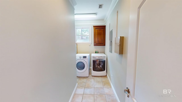 1651 Laurel St, Mobile, AL 36604 - laundry room featuring washer and dryer, cabinet space, baseboards, ornamental molding, and light tile patterned flooring